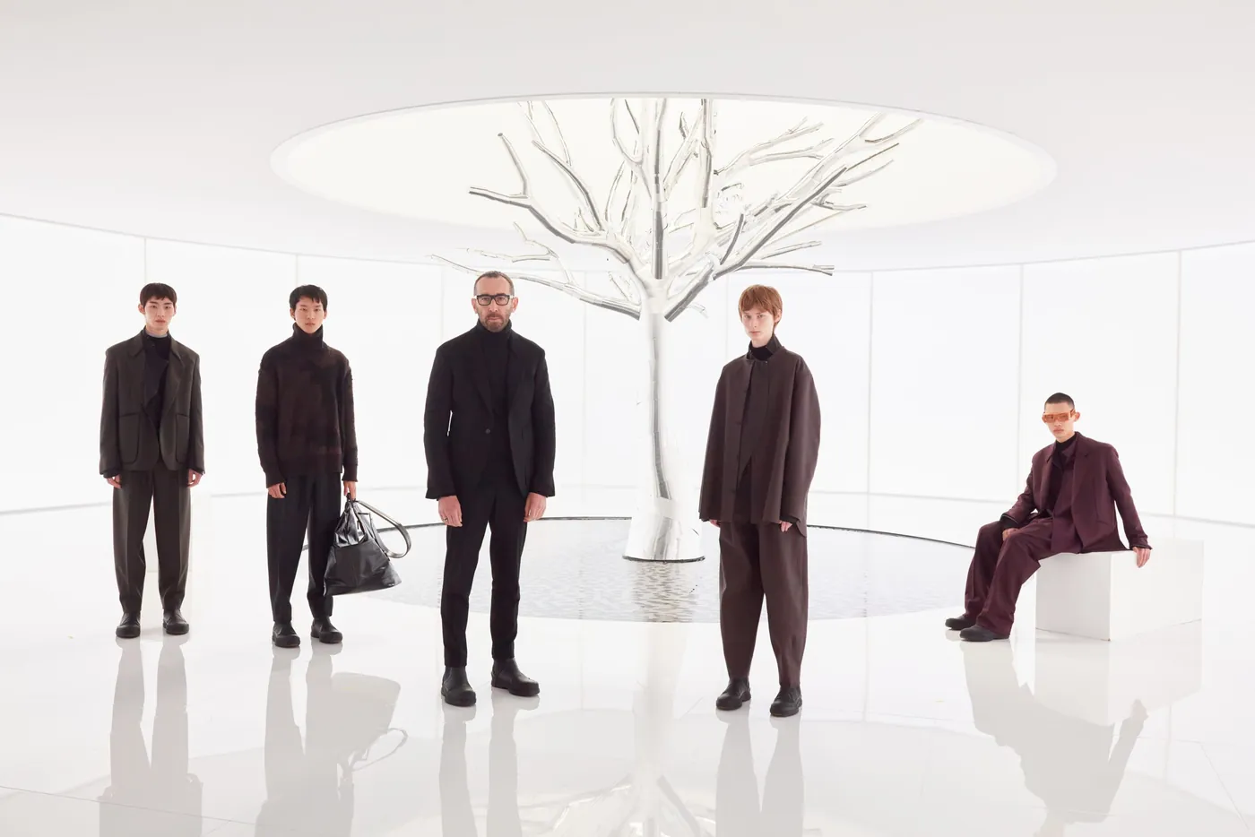 Models around a white metal tree in a still from the ZEGNA FW22 film